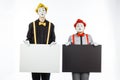 Two funny mimes holding a white blank on a white background.