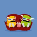 Two funny monsters watching scary horror movie wearing 3d glasses, sitting on red couch, and eating snacks.