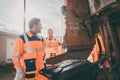 Two garbagemen working together on emptying dustbins