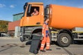 Two garbagemen working together on emptying dustbins