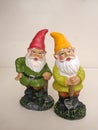 Two garden gnomes in front of a neutral background Royalty Free Stock Photo