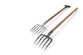 Two garden pitchforks on a light background. Space for text. Royalty Free Stock Photo