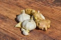 Two garlic bulbs and funnels with ginger root for health and organic medical care Royalty Free Stock Photo
