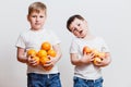 Two boy with oranges in the hands Royalty Free Stock Photo