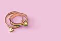 Two gay male wedding rings isolated on pastel pink background. Copy space included. LGBTQ+ people right to live together concept.