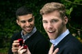 Engagement proposal betwen two gay men as one man proposes with an engagement ring in red box Royalty Free Stock Photo