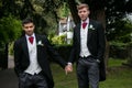 Gay couple of grooms pose for photographs after their wedding ceremony