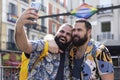 Two gay men on vacation taking a photo together with mobile phone during a sightseeing tour in a city Royalty Free Stock Photo