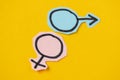 Two gender symbols Venus and Mars cut from blue and pink paper. Heterosexuality