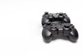 Two generic black gaming controllers. Isolated on white background. Copy space