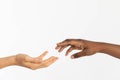 A helping hand outstretched to give support. Two hands approaching each other. Hands of two races, African and European