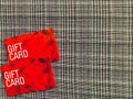 Red Gift card on Glen check plaid background. Royalty Free Stock Photo