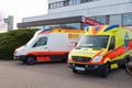 Two german ambulance vehicles stands on hospital