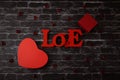 Two red heart gift box and word love tree on black brick background. Royalty Free Stock Photo