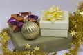 Two gift boxes and a golden ball, beads on a light background Royalty Free Stock Photo