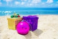 Two gift boxes with Christmas ball on the beach - holiday concept Royalty Free Stock Photo