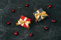 Two gift boxes and red Christmas balls on black background. Top view, flat lay Royalty Free Stock Photo