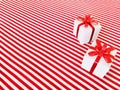 Two white gift boxes with red ribbon bow on a red and white stripes diagonals background Royalty Free Stock Photo