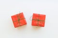 Two gift boxes wrapped in red paper tied with green ribbon. White background. Holiday New Years Christmas Royalty Free Stock Photo