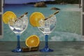 Two gin tonics with orange on the beach Royalty Free Stock Photo