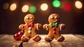 Two gingerbread man dancing on the wooden kitchen table with colorful bokeh in the background Royalty Free Stock Photo