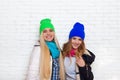 Two girl couple smile wear winter colorful hats jacket