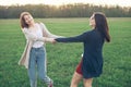 Two girl dancing on the green field Royalty Free Stock Photo