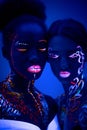 Two girl with fluorescent make-up isolated Royalty Free Stock Photo