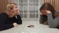 Girl friends play uno cards at table