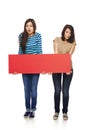 Two girl friends with red banner Royalty Free Stock Photo