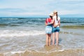 Two girl friends on the sea shore hugging each other Royalty Free Stock Photo