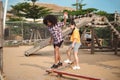 Two girl kid walks on a log, keeping her balance, walking on the playground Royalty Free Stock Photo