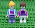 Two girl Lego on green background