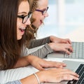 Two girl typing on laptops. Royalty Free Stock Photo