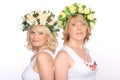 Two girlfriends blonde women in wreaths, smiling, standing backs Royalty Free Stock Photo