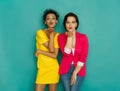 Two girlfriends blowing kisses at azur studio background Royalty Free Stock Photo