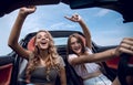 Two girlfriends enjoying a trip in the car Royalty Free Stock Photo