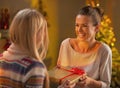 Two girlfriends exchanging christmas presents Royalty Free Stock Photo