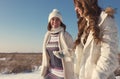 Two girlfriends have fun at beautiful winter day