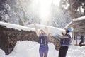 Two girlfriends have fun and enjoy fresh snow on a beautiful winter day Royalty Free Stock Photo