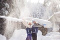 Two girlfriends have fun and enjoy fresh snow on a beautiful winter day Royalty Free Stock Photo