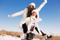 Two girlfriends have fun and enjoy fresh snow