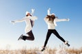 Two girlfriends have fun and enjoy fresh snow