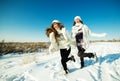 Two girlfriends have fun and enjoy fresh snow