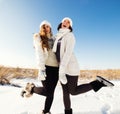 Two girlfriends have fun and enjoy fresh snow Royalty Free Stock Photo