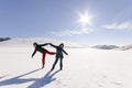 Two girlfriends have fun and enjoy the fresh snow Royalty Free Stock Photo