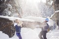 Two girlfriends have fun and enjoy fresh snow on a beautiful winter day Royalty Free Stock Photo