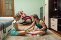Two girlfriends have fun playing with toys on the carpet Royalty Free Stock Photo