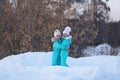 Two girlfriends have fun. Winter walks of girls in the woods, good weather. Joyful meeting and hugs