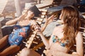 Two girlfriends having fun with VR glasses and smartphone on beach